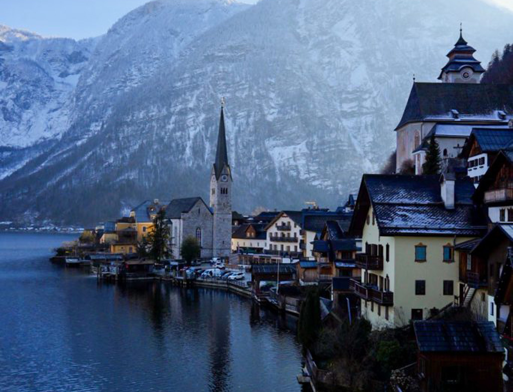 Skyline view of Hallstatt with mountains in the background and a lake in the foreground.